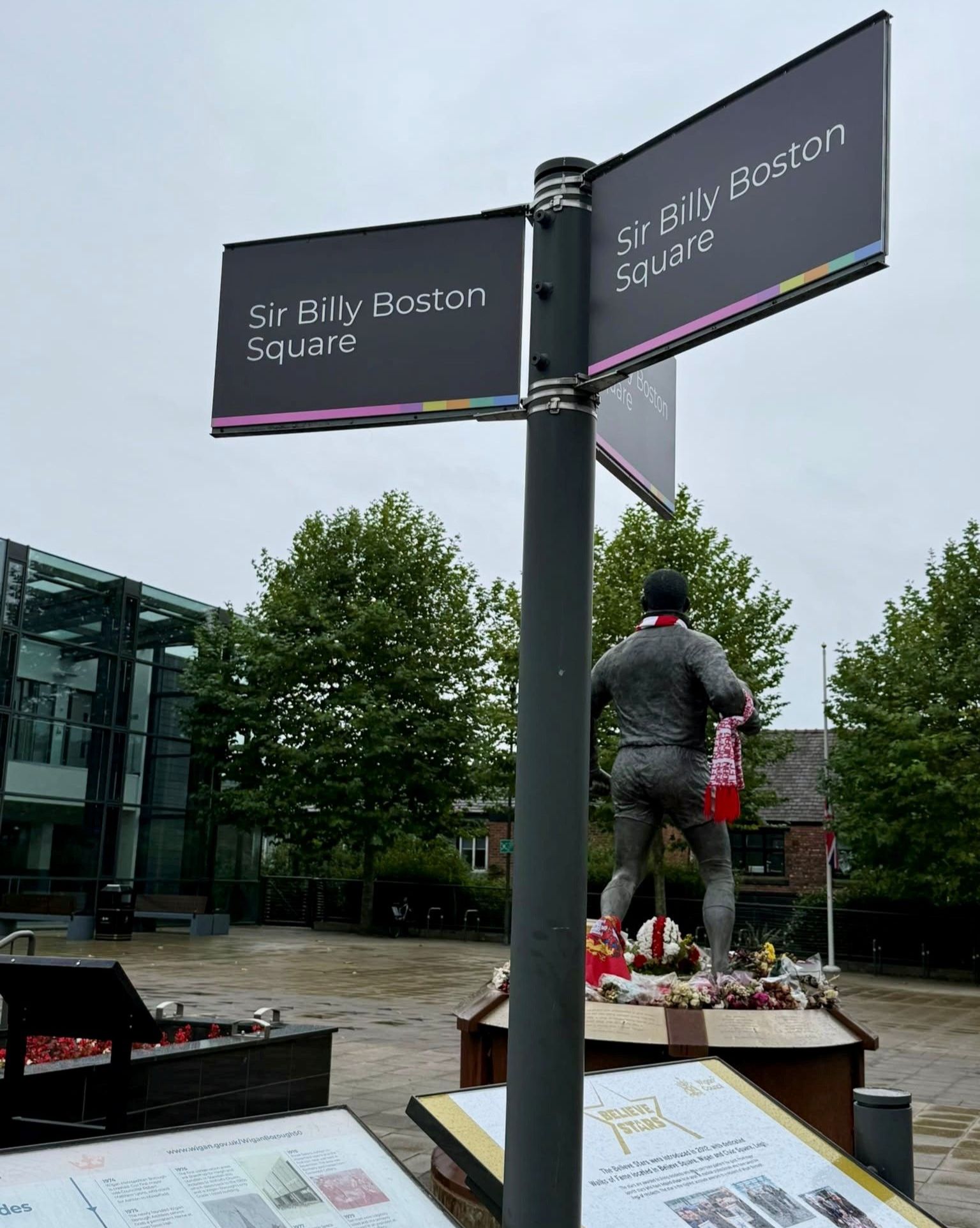 New signs reading Sir Billy Boston Square, with the Sir Billy Boston statue in the background New signs reading Sir Billy Boston Square, with the Sir Billy Boston statue in the background